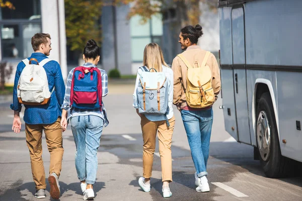 Rear View Friends Rucksacks Walking Travel Bus Street — Stock Photo, Image