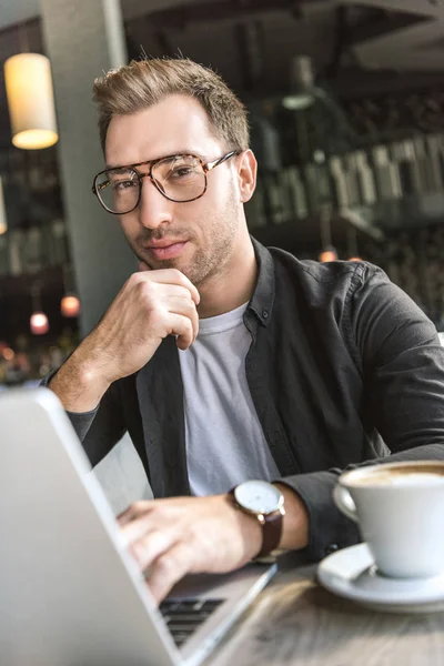 Handsome Young Freelancer Working Laptop Cafe Looking Camera — Free Stock Photo