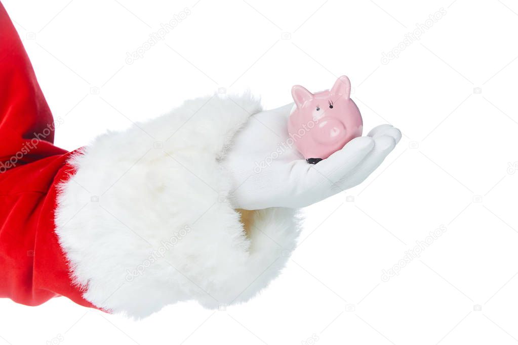 cropped view of santa claus holding little piggy bank in hand isolated on white