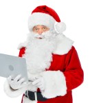 Bearded santa claus using laptop isolated on white
