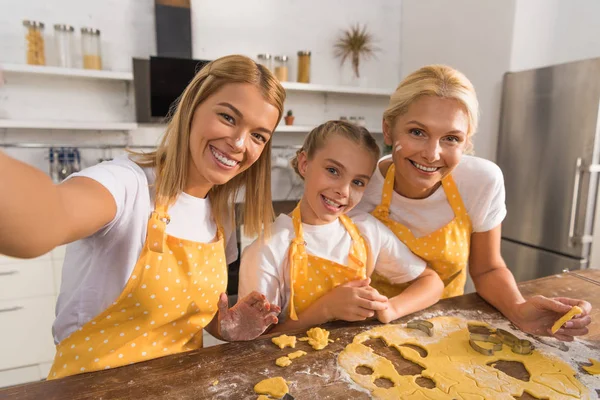 Happy Child Mother Grandmother Smiling Camera While Preparing Cookies Together — Free Stock Photo