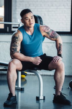 spor salonunda oturan genç Asyalı sporcu 