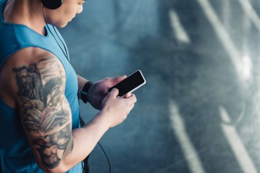 Smartphone kullanarak ve müzik genç sporcu 