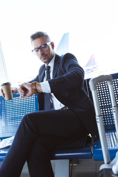 Businessman Glasses Sitting Window Coffee Looking Watch Airport — Free Stock Photo