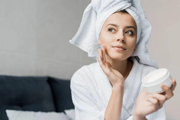 Menina Bonita Com Toalha Cabeça Aplicando Creme Cosmético Rosto — Fotografia de Stock