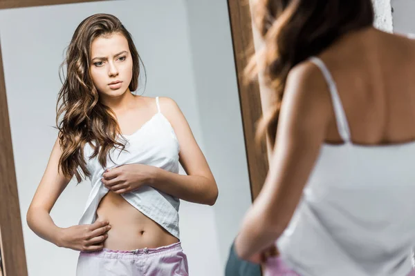 Upset Young Woman Looking Her Waistline Mirror — Stock Photo, Image