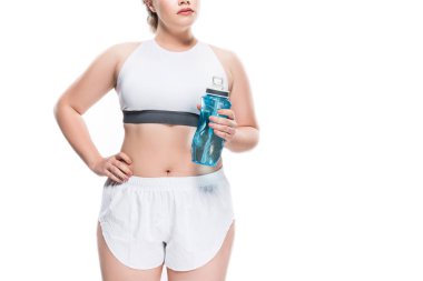 cropped shot of oversize girl in sportswear holding bottle of water isolated on white clipart