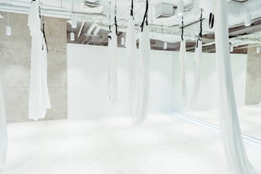 Light white spacious studio equipped for antigravity yoga clipart