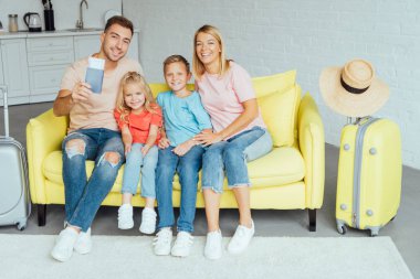 mutlu aile pasaport holding, yaz tatili için Bagaj paketleme ve harika vakit geçiriyor seyahat kavramı