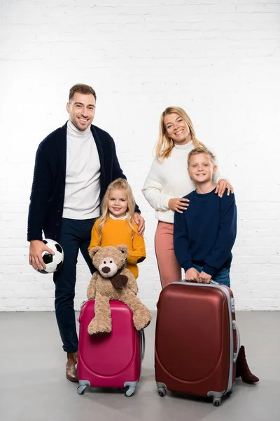 Happy Family Ready Winter Holidays Luggage Looking Camera White Background — Free Stock Photo