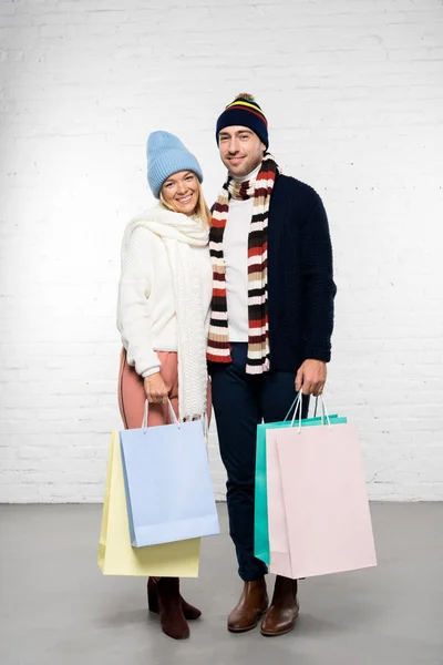 Husband Wife Winter Clothes Looking Camera Holding Shopping Bags — Free Stock Photo