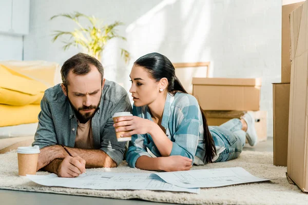 Handsome Husband Wife Lying Floor Drinking Coffee Working Blueprints New — Free Stock Photo