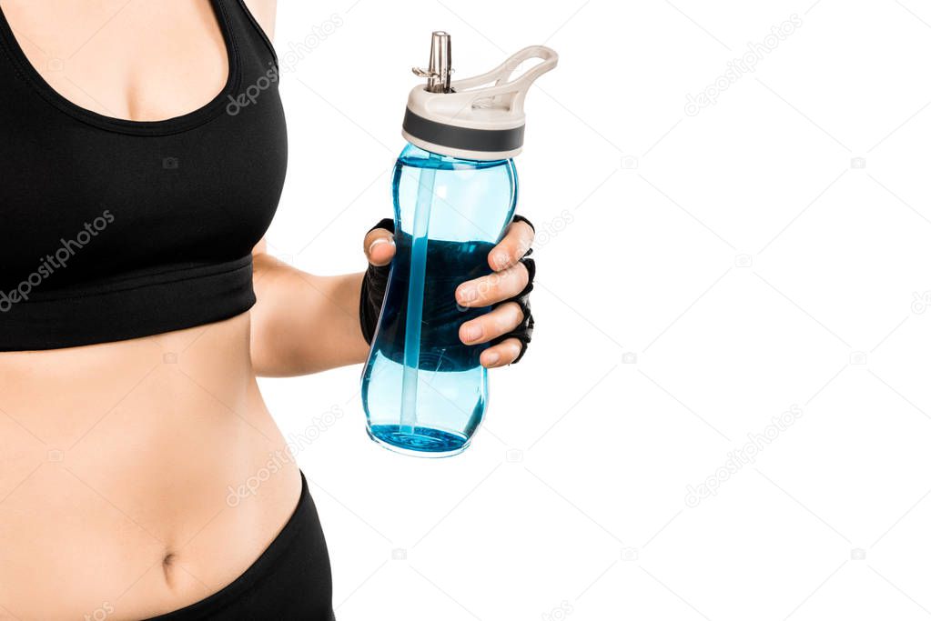 partial view of sportswoman holding sport bottle isolated on white