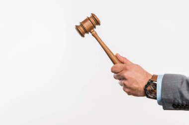 close-up partial view of male judge holding wooden hammer isolated on white  clipart