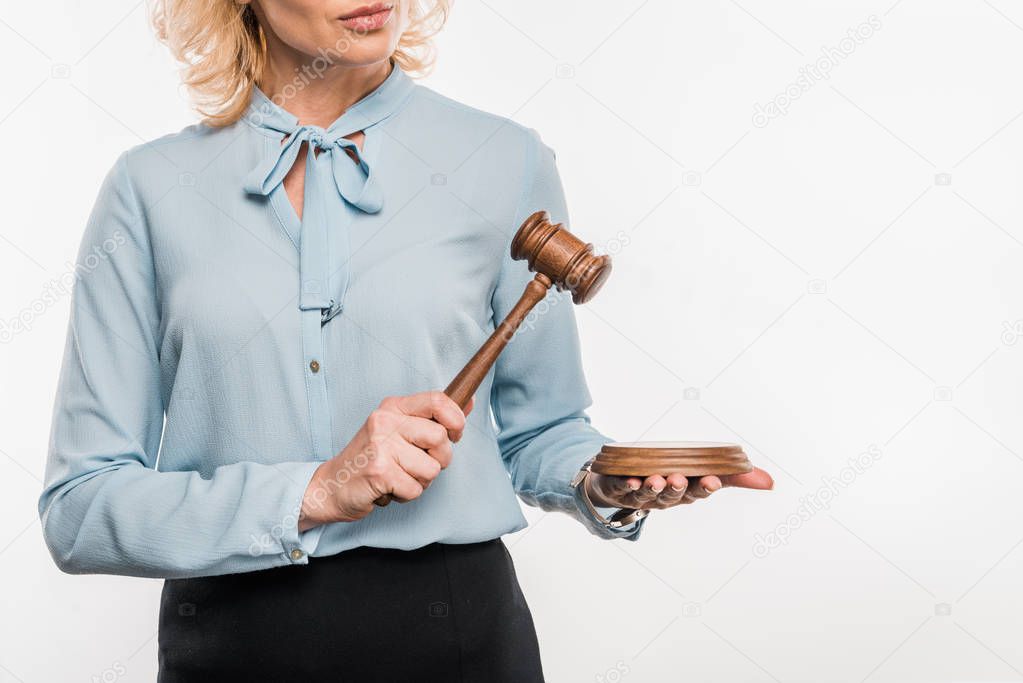 cropped shot of female judge holding hammer isolated on white   
