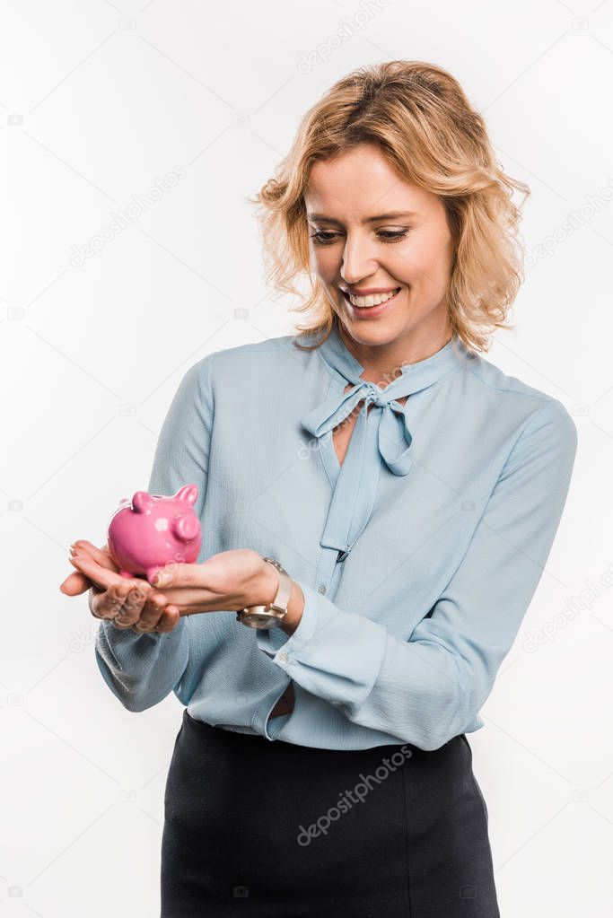 beautiful smiling businesswoman holding pink piggy bank isolated on white  