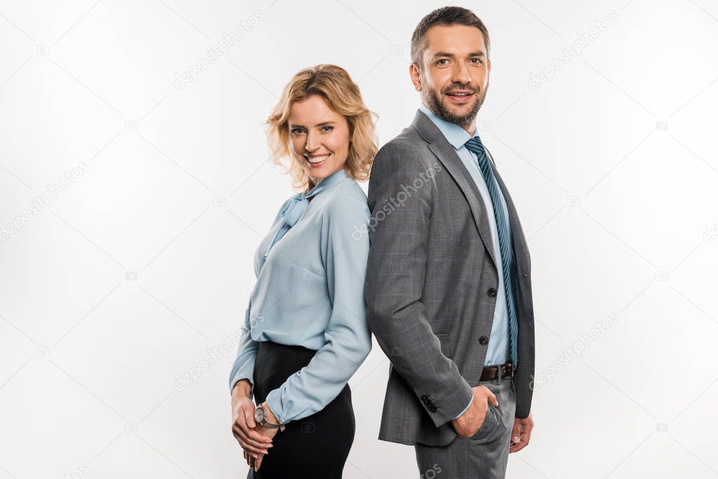 side view of professional business colleagues standing together and smiling at camera isolated on white   