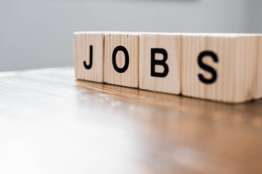 close-up shot of wooden blocks with JOBS sign on table clipart