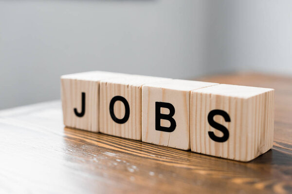 close-up shot of wooden cubes with JOBS sign on table