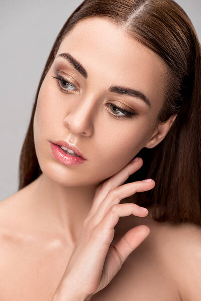 portrait of beautiful tender girl with perfect clean face, isolated on grey