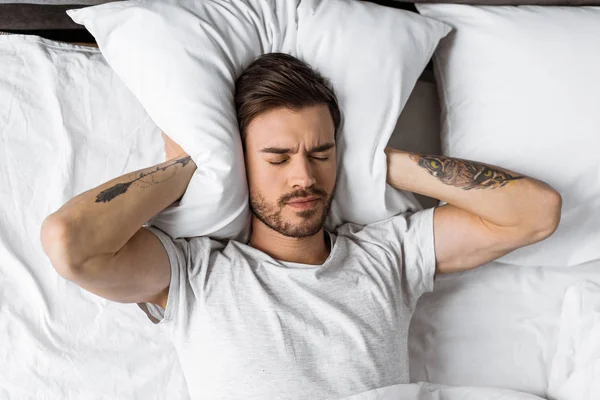 Young Man Closing Ears Pillow Bed Morning — Stock Photo, Image