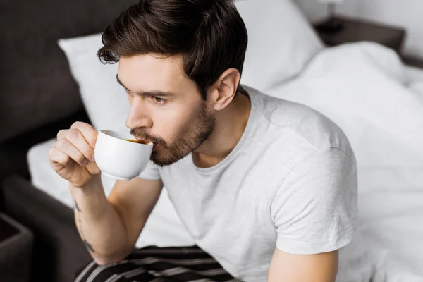 Высокий Угол Зрения Молодого Человека Сидящего Кровати Пьющего Кофе Утрам — Бесплатное стоковое фото