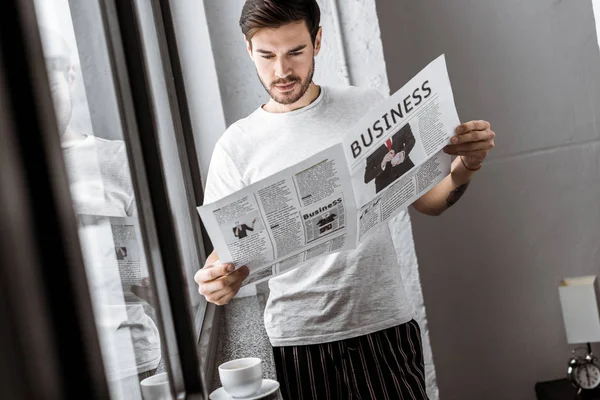 Handsome Young Man Reading Business Newspaper Home — Free Stock Photo