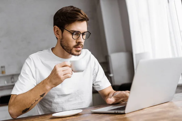 Jovem Freelancer Confiante Com Café Trabalhando Com Laptop Casa — Fotografia de Stock