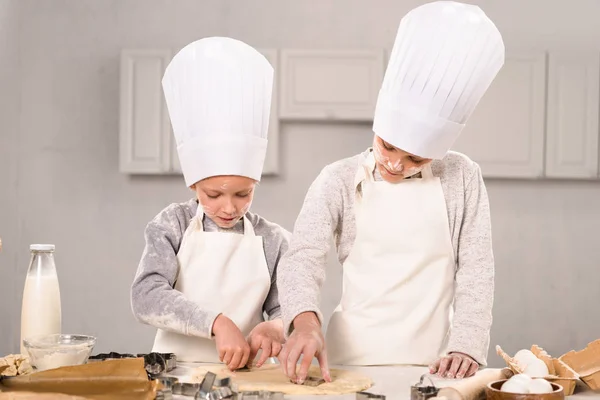 Adorable Little Brother Sister Chef Hats Aprons Cutting Out Dough — Free Stock Photo