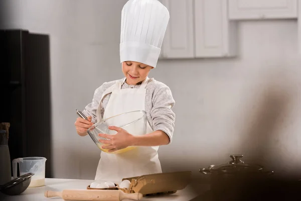 Selective Focus Happy Boy Chef Hat Apron Whisking Eggs Bowl — Free Stock Photo