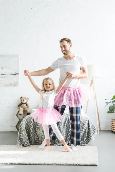 Happy Father Daughter Pink Tutu Skirts Holding Hands Dancing Together — Free Stock Photo