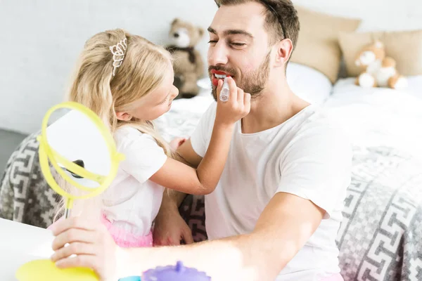 Cute Little Daughter Applying Red Lipstick Happy Bearded Father Looking — Free Stock Photo