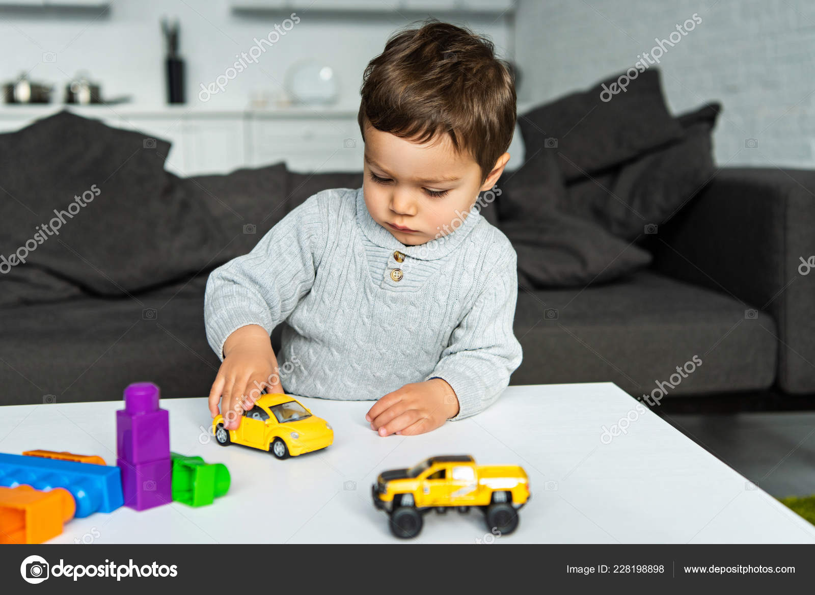 kid playing with toy car