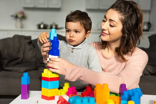 Smiling Mother Little Son Playing Colorful Plastic Blocks Home — Stock Photo, Image