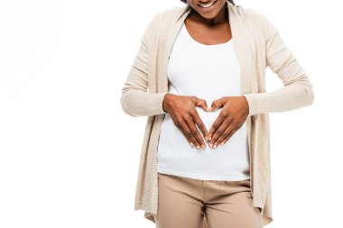 pregnant african american woman smiling and touching belly isolated on white clipart