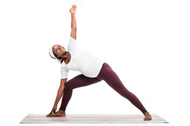 african american pregnant woman making yoga exercises on floor isolated on white clipart