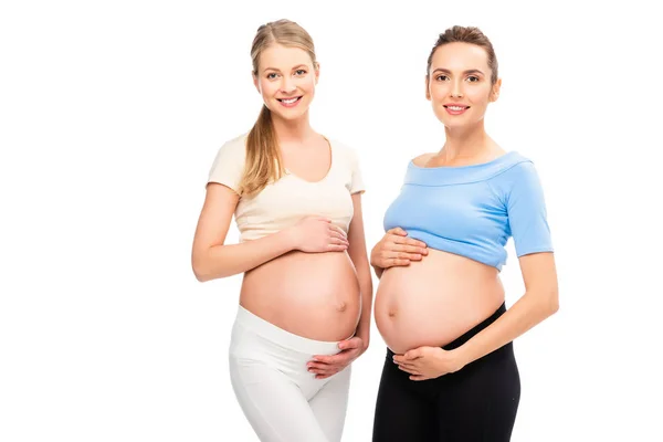 Dvě Těhotné Ženy Ukazující Břicha Navzájem Izolované Bílém — Stock fotografie