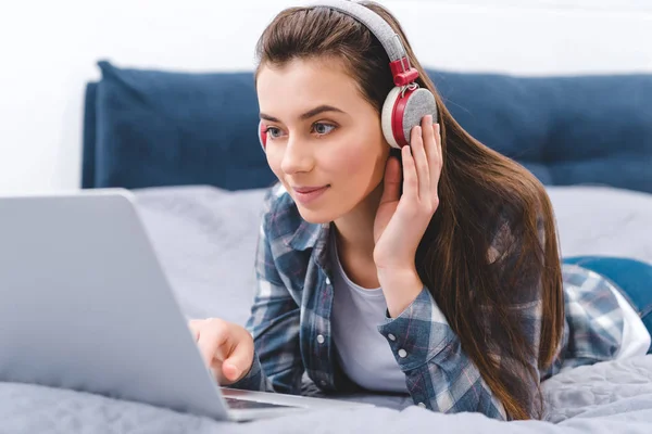 Beautiful Smiling Young Woman Headphones Using Laptop While Lying Bed — Stock Photo, Image