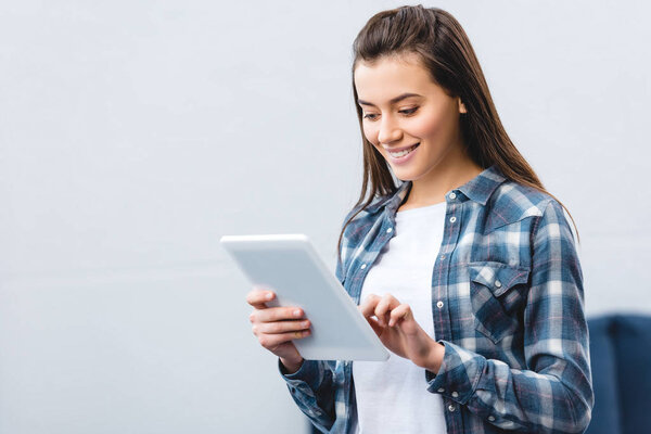 beautiful smiling young woman using digital tablet