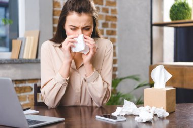 young businesswoman suffering from allergy at workplace  clipart