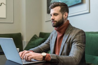 yakışıklı sakallı iş adamı masada oturan ve laptop restoranında tipik formal giyim