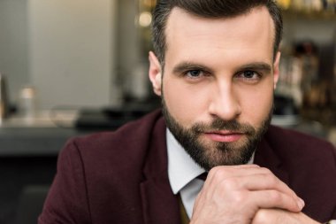 kameraya bakarak katlanmış ellerle formal giyim yakışıklı sakallı işadamı portresi