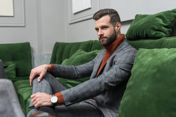 Confident Man Formal Wear Legs Crossed Sitting Green Sofa — Stock Photo, Image