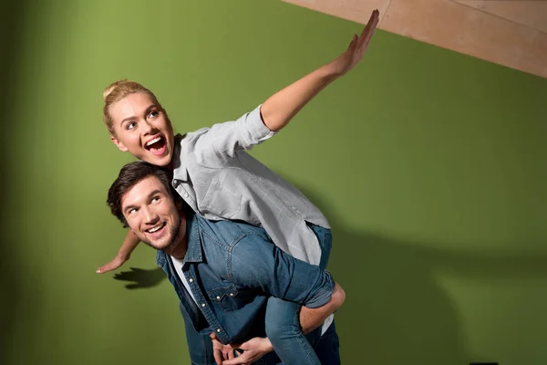 Smiling Man Giving Piggyback Ride Cheerful Wife Apartment — Free Stock Photo