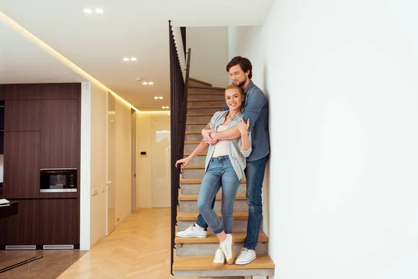 Handsome Man Embracing Beautiful Wife Stairs Home — Stock Photo, Image