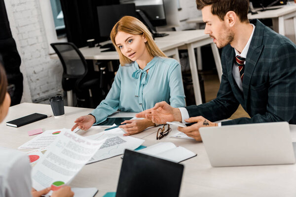 business colleagues discussing work during meeting in office