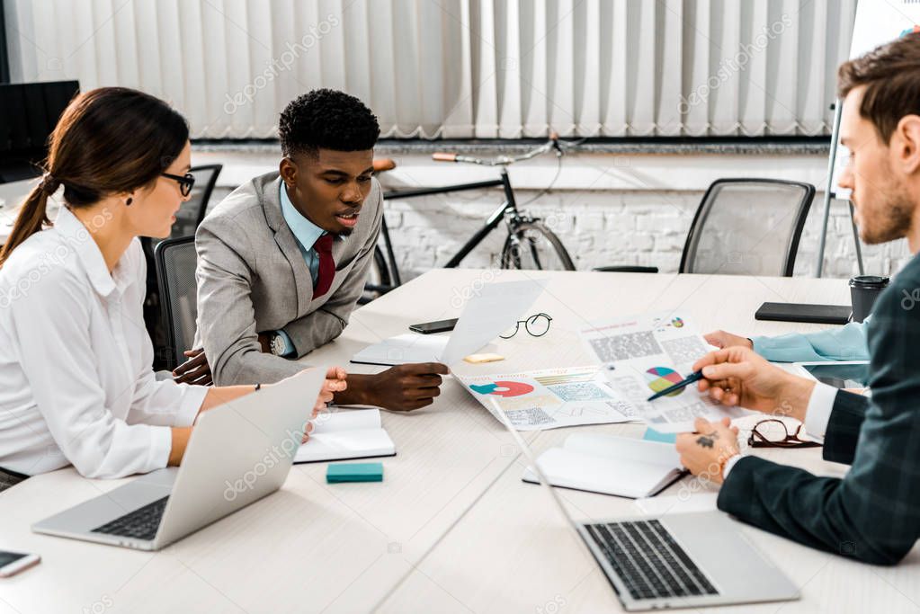 group of multiethnic businesspeople having discussion during meeting in office