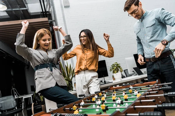 Emotional Business Colleagues Playing Table Football Together Office — Free Stock Photo