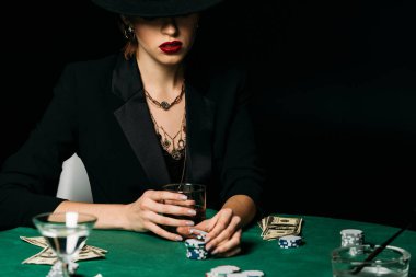 çekici kız ceket ve şapka holding bardak viski ve alarak poker chip casino