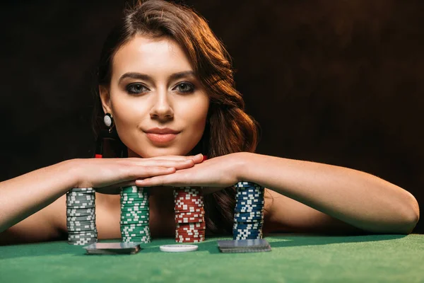 Attractive Brown Haired Girl Leaning Poker Chips Looking Camera Isolated — Stock Photo, Image